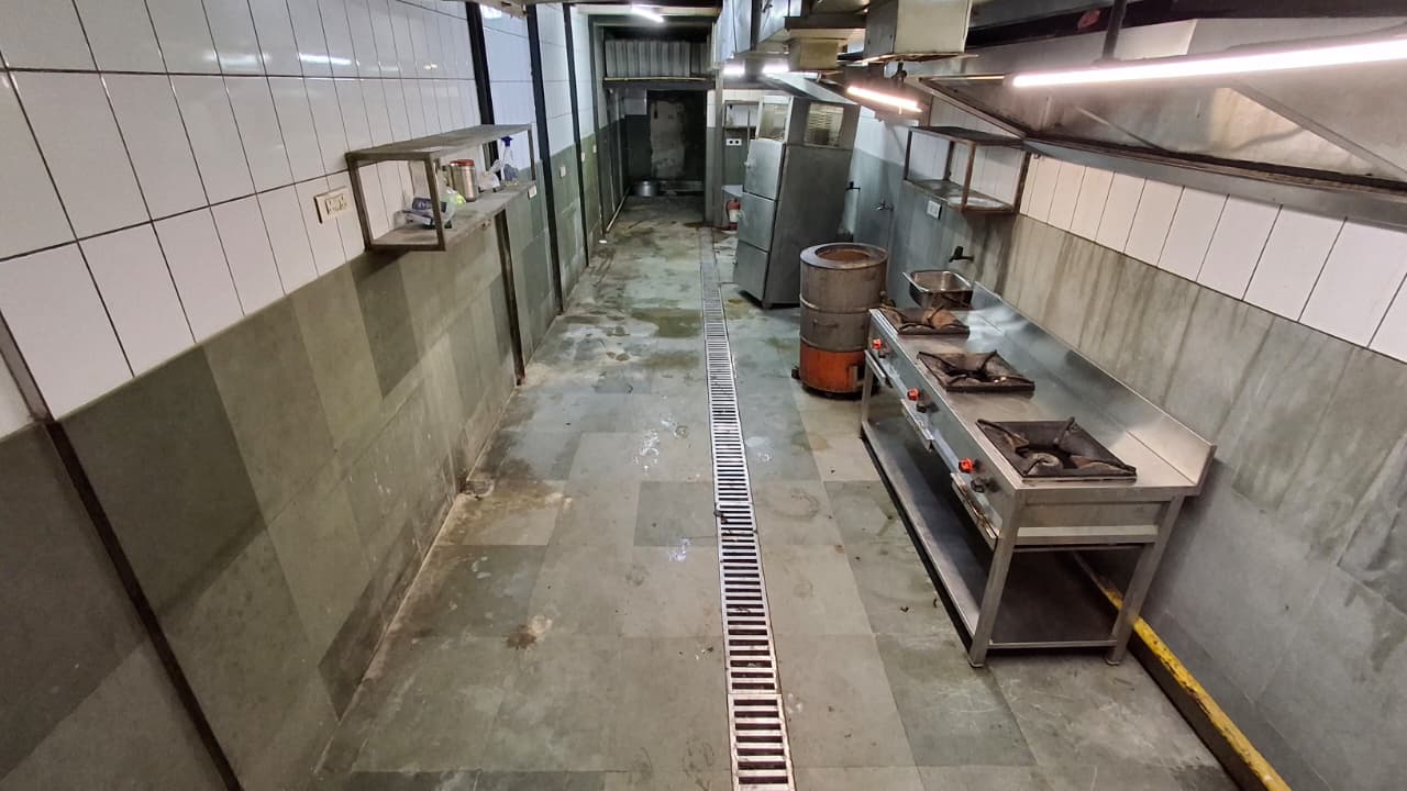 Actual kitchen interior showing the cooking area and extraction hood